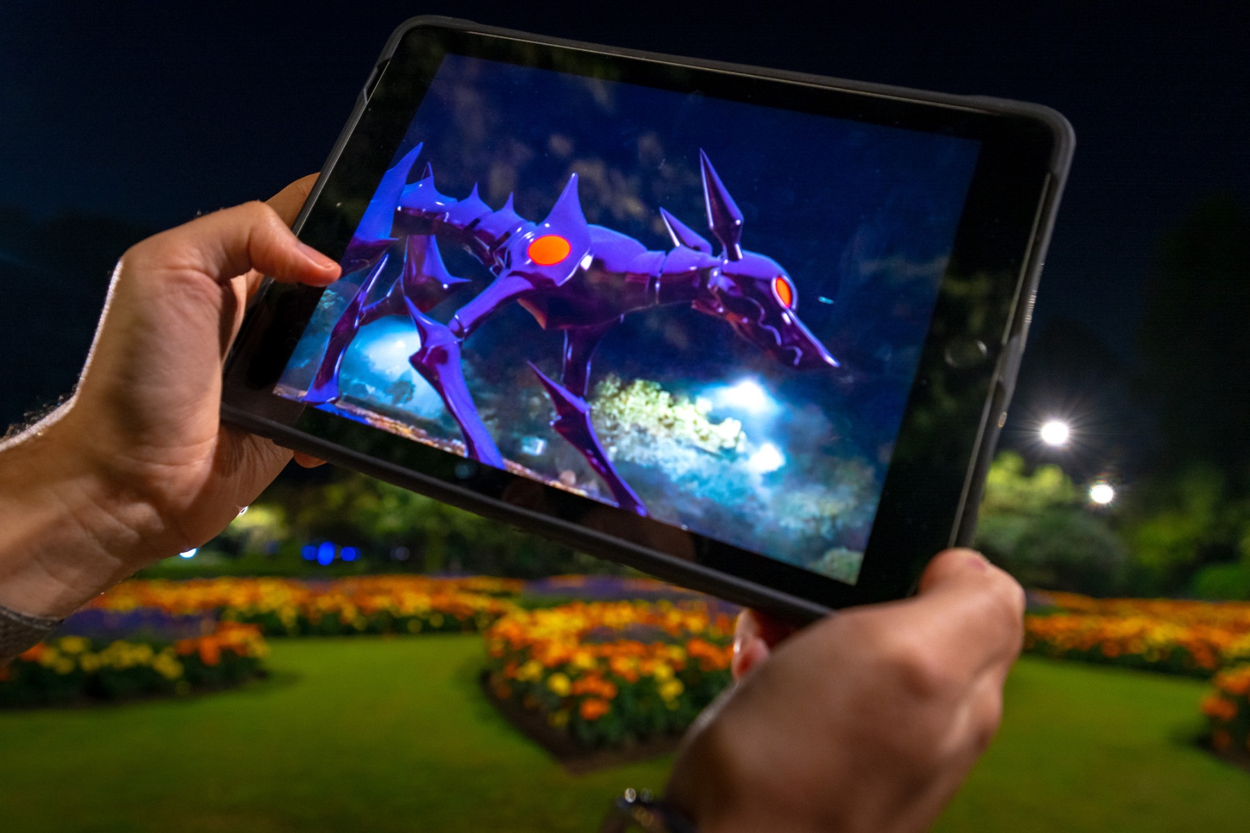 A gigantic, robotic creature looms above the Botanic Gardens’ decorative flower beds on a spectator’s tablet screen