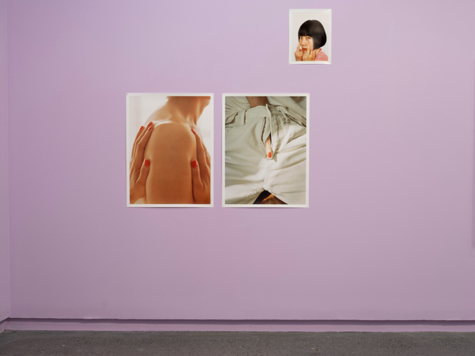Intimate photographs of Chinese couples and individuals hang on lilac-gallery walls
