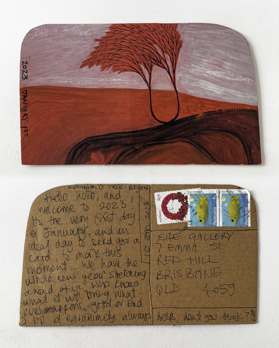 A composite photograph depicts two sides of a brown cardboard postcard. At the top is a painting of a red tree blowing in a red landscape, below is a message marking the start of the year