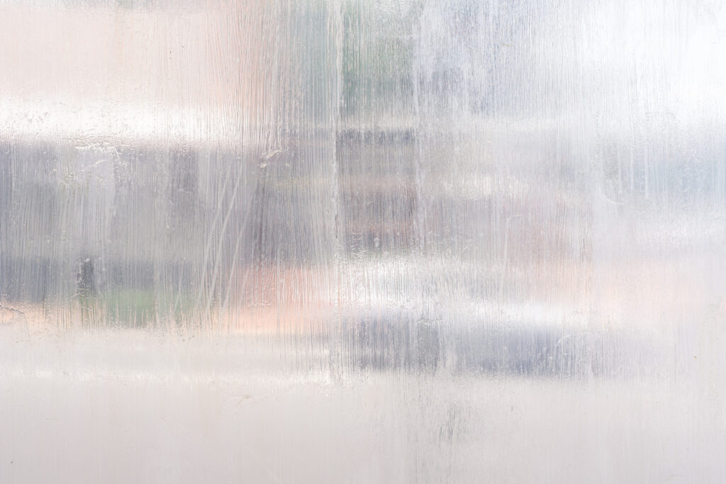 A delicate translucent glaze is washed against a window, disguising the street traffic beyond.