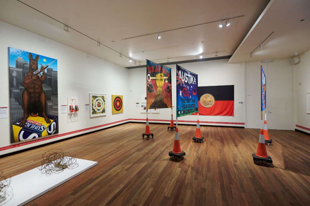 Multiple artworks by Indigenous art collective, proppaNOW, hang in a gallery.