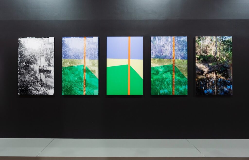 Five images hang on a gallery wall: to the far left and right are two landscapes, in the middle are geometric shapes that highlight the photograph’s shared compositional structure.