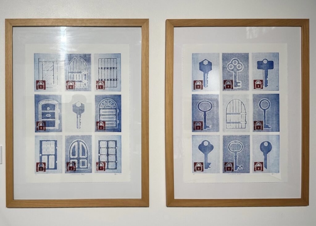 Two side-by-side paintings in timber frames depict a grid of nine gates, doors, and keys.