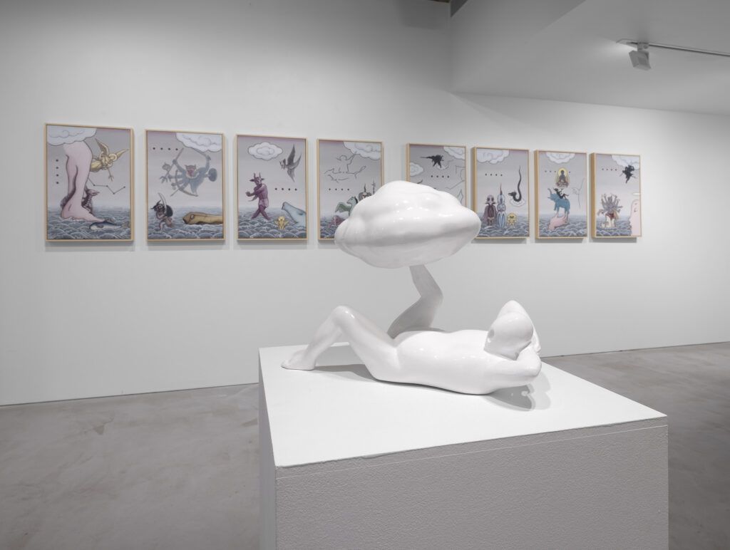 In the foreground is a white-enamelled bronze sculpture of a figure reclining and balancing a cloud upon their foot. Behind it hangs a series of eight paintings depicting mythological beings.