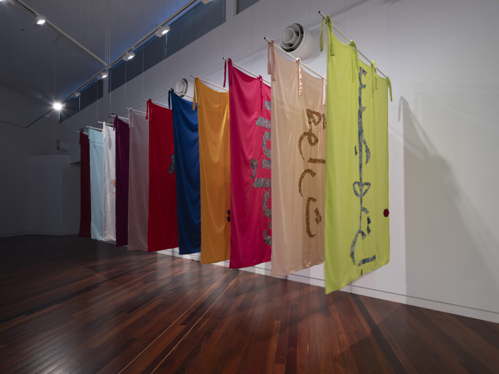 A series of coloured textiles in a row.